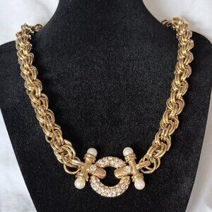 Gold tone necklace with faux diamonds and faux pearl accents.